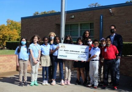 Populus Financial Group presents a $15,000 donation to Jan Murfield, JA Dallas president, at J.O. Davis Elementary School